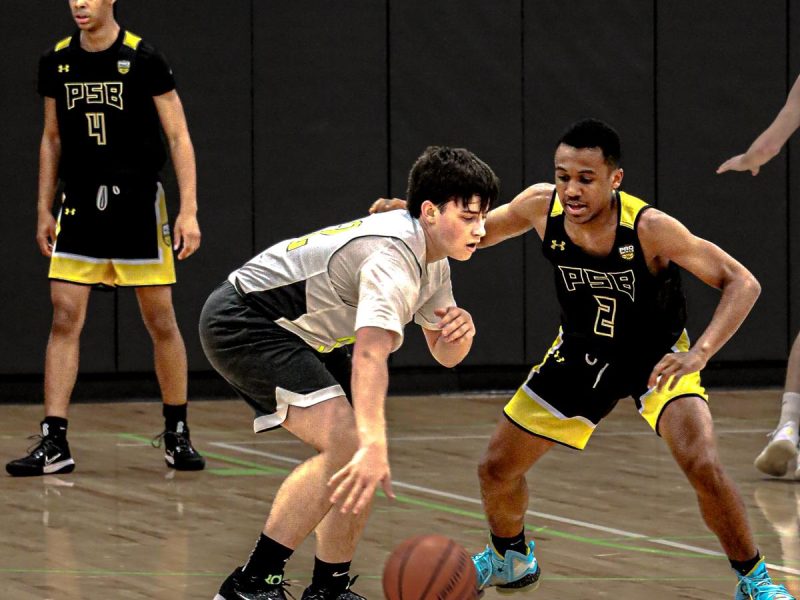 Youth Basketball Player dribbles past opponent during a Pro Skills Basketball game