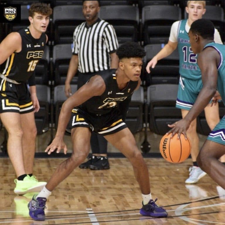 High School Pro Skills Youth Basketball Player defends against opponent during a basketball game