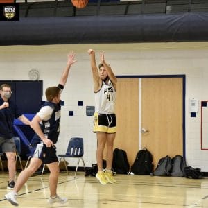 Pro Skills Basketball player takes a jump shot during a youth basketball game